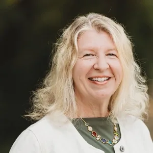 Dr. Elizabeth Phillips, DDS, FAGD, MPH, of Tonka Smiles, smiling outdoors.