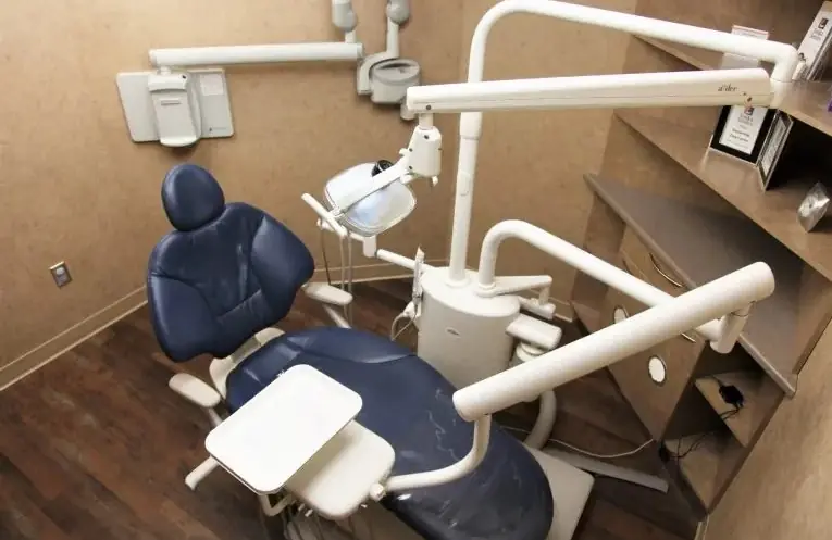 A treatment room at Tonka Smiles with a navy dental chair.