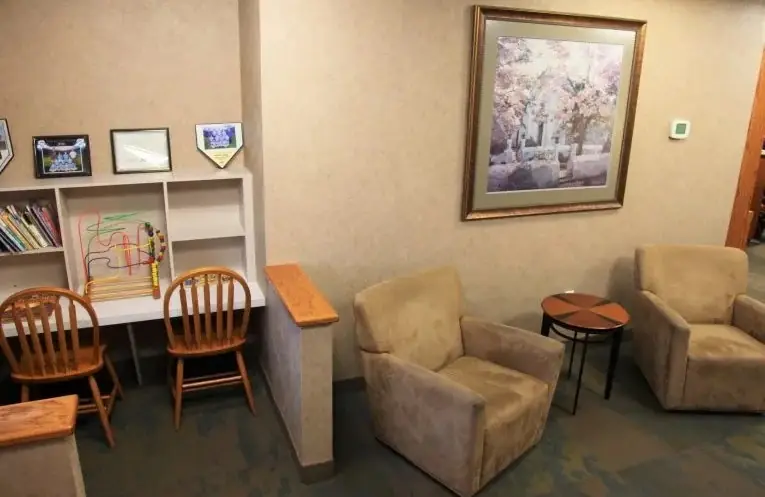 The children's corner of the Tonka Smiles waiting room, with small chairs and books.