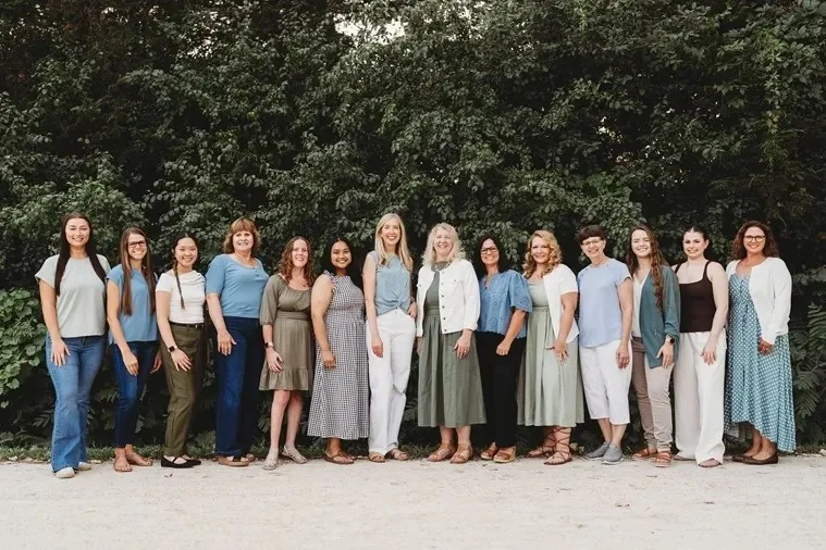 The Tonka Smiles team standing in a row outdoors.